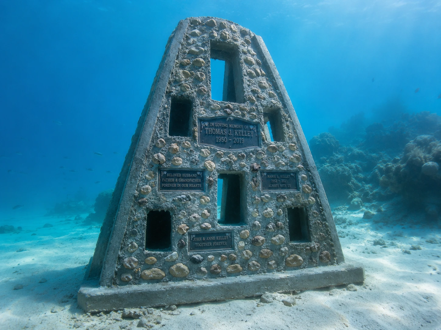 The Sacred Reef Family Memorial Reef, a large pyramid memorial reef with multiple personalized plaques on the seafloor.
